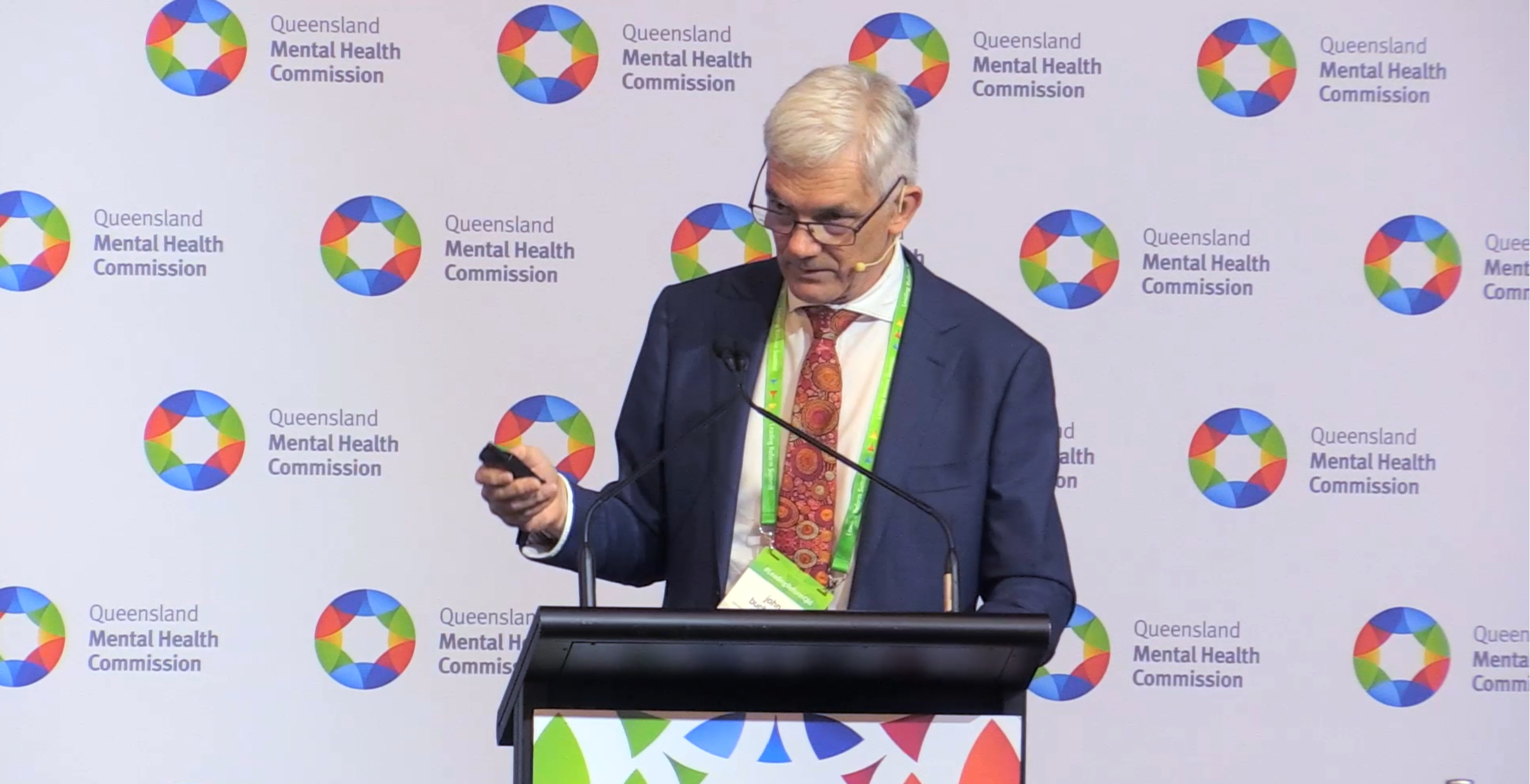 Image of John Buchanan with play video text